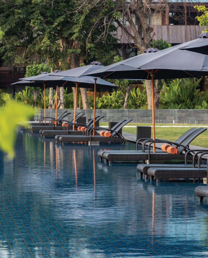 Loungers by the Olympic-sized beachfront pool at the Bali Beach Hotel, Sanur